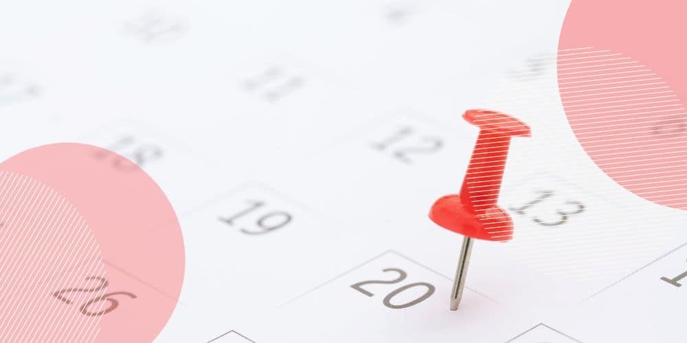 calendário com uma tachinha vermelha pregada sobre o dia 20 do mês